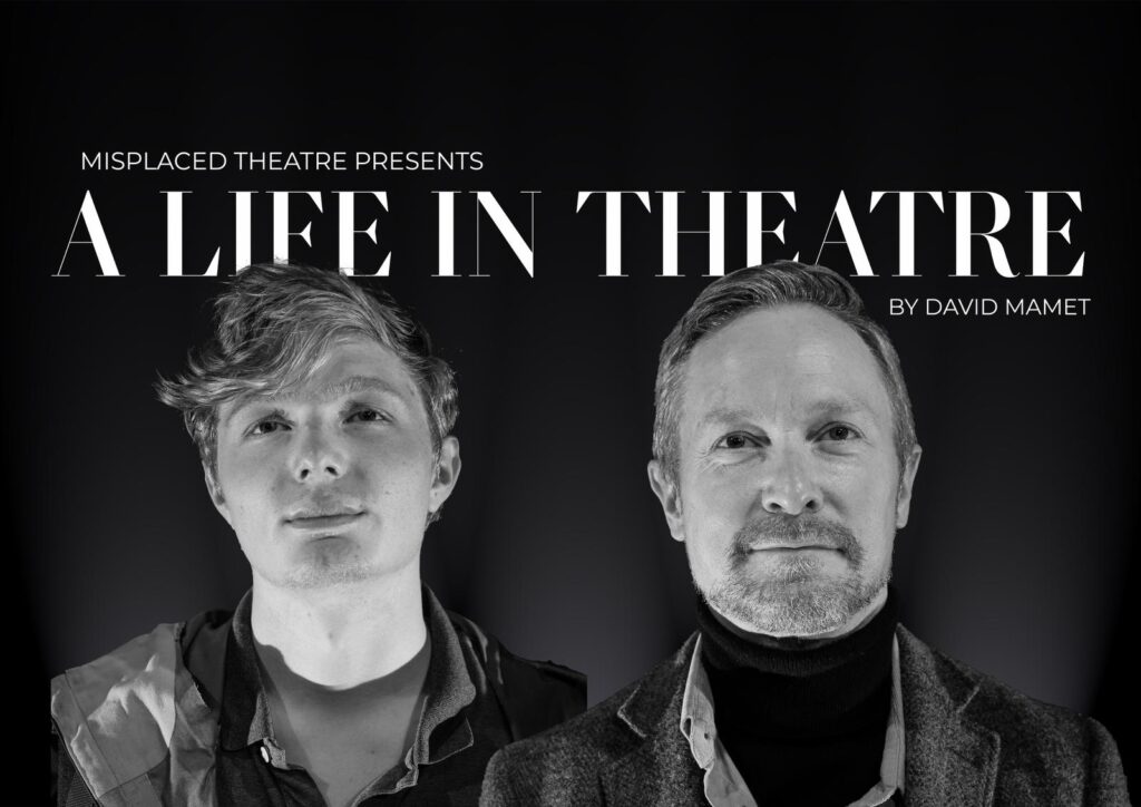 A young actor and an older actor stand facing the stage lights